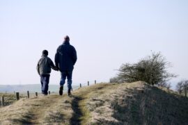 Father And Son Walking On A Mountain